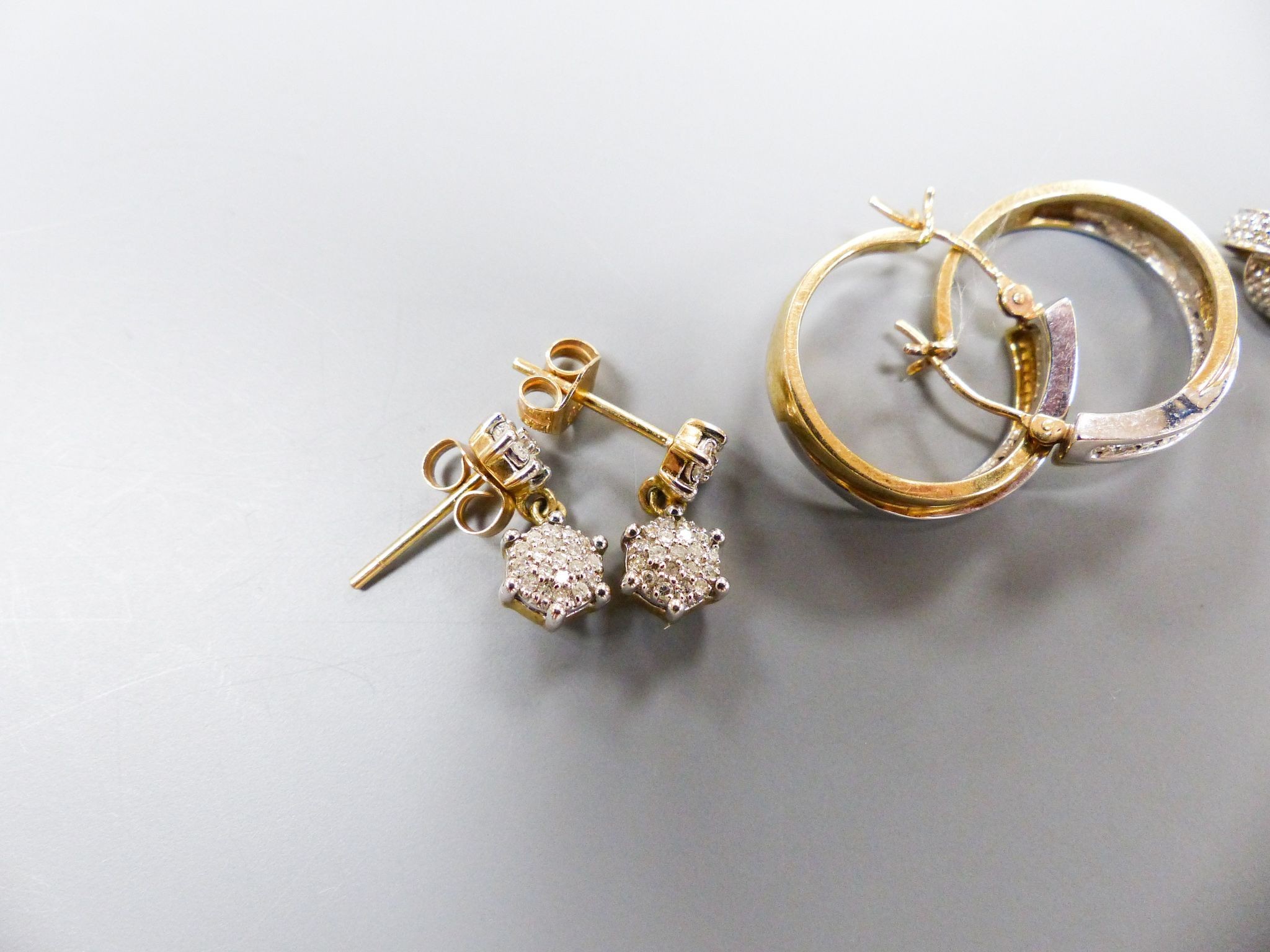 Four assorted modern pairs of 9ct and diamond chip set earrings, largest 18mm, gross weight 8.4 grams.